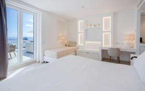 a white bedroom with a white bed and a window at Pagoda Lifestyle Hotel in Ischia