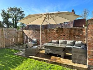 a patio with an umbrella and two couches and an umbrella at Secluded Quiet Country Escape 