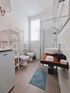 a bathroom with a sink and a tub and a toilet at MonteRoom-Apartments in Bologna