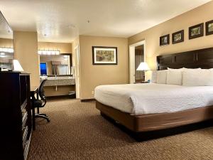 een hotelkamer met een bed en een bureau bij Best Western Country Inn in Fortuna