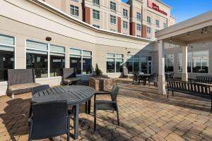 a patio with a table and chairs and a building at Hilton Garden Inn Findlay in Findlay