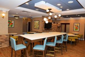 a dining room with a large table and chairs at Hampton Inn Atlanta-Canton in Canton