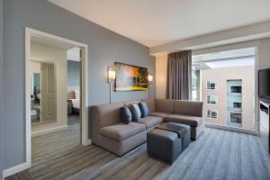 a living room with a couch and a tv at Hyatt House San Jose-Silicon Valley in San Jose