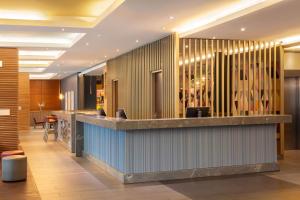 a lobby of a hotel with a reception counter at Hampton by Hilton Berlin City West in Berlin