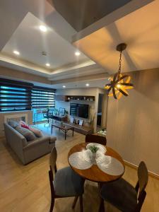 a living room with a dining table and a couch at Exquisite Stays Private 2BR Rental in Manila