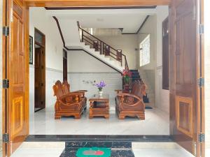 a hallway with wooden furniture and a staircase at Nybipu Homestay in Phan Rang