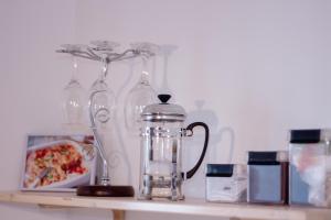 a counter with glasses and a blender on a shelf at Ērti un Mājīgi in Liepāja