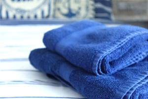 a pile of blue towels sitting on a table at The Captain's Lodge Looe in Looe