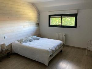 a bedroom with a bed in a room with a window at La Maison de Julise in Cossé-le-Vivien +18 photos