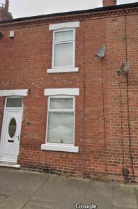 a brick building with two windows and a door at Chelmsford House By Horizon Stays in Darlington