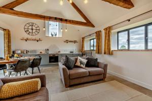 a kitchen and living room with a couch and chairs at Fox in Charlbury