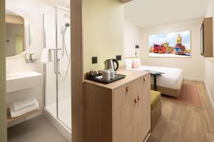 a bathroom with a sink and a shower in a room at Hampton By Hilton London Old Street in London