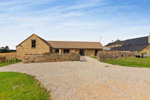 a stone house with a stone driveway at Fox in Charlbury