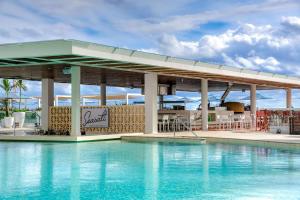 a pool at a resort with a bar at Hilton Cancun Mar Caribe All-Inclusive Resort in Cancún