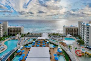 an aerial view of a resort with a pool and the ocean at Hilton Cancun Mar Caribe All-Inclusive Resort in Cancún