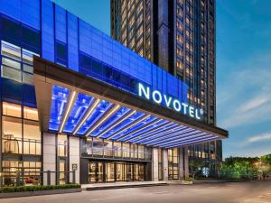 a building with a novemberico sign on it at Novotel Shanghai JingAn in Shanghai