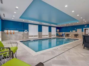a swimming pool in a room with blue walls at Hampton Inn & Suites Cincinnati Midtown Rookwood in Cincinnati