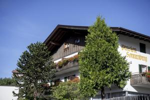 a building with two trees in front of it at Sonnenberg in Silandro