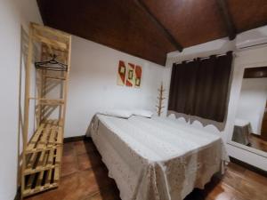 a bedroom with a bed and a wooden ladder at CLA - Aotearoa in Farol de Santa Marta