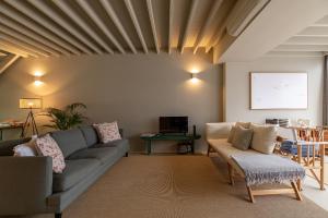 a living room with a couch and a table at Guava Azores in Ribeira das Tainhas