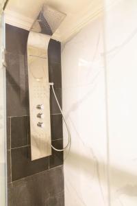 a shower in a bathroom next to a window at Residence La Perle de l'Atlas Marrakech in Marrakech