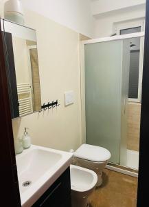 ein weißes Bad mit einem WC und einem Waschbecken in der Unterkunft Pretty Little Home in Mailand