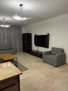 a living room with a couch and a flat screen tv at Krawiecka 3 - City Center - 7 People - Private Parking in Wrocław