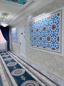 a room with a hallway with blue tiles on the wall at Diplomat Premium Hotel in Samarkand