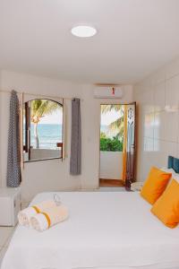 a bedroom with a bed with a view of the ocean at Pousada Estrela da Luz Beach in Ceará-Mirim