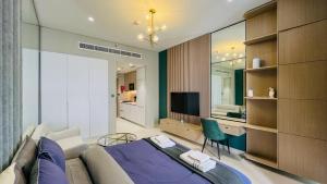 a bedroom with a bed and a television in it at Modern Studio- 115 Westwood Al furjan in Dubai