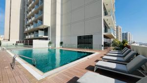 a swimming pool on the roof of a building at Modern Studio- 115 Westwood Al furjan in Dubai