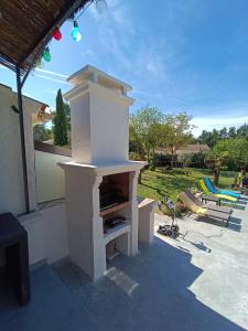 a outdoor oven sitting on top of a patio at Villa les Doms in Mazan