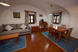 a living room with a couch and a table at Wine Grower's Mansion Zlati Gric in Slovenske Konjice