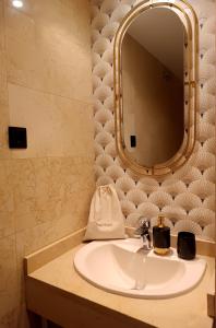 a bathroom with a sink and a mirror at Fridda House Atocha Madrid in Madrid