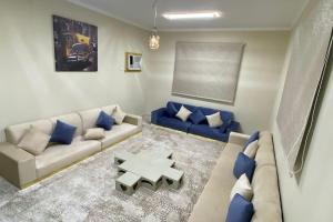 sala de estar con sofá y mesa en Palm Villa, en Al Ula