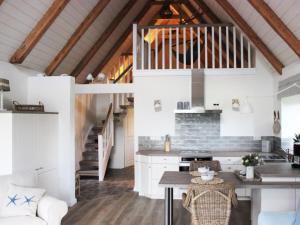 a kitchen with white walls and wooden ceilings at Cathedral day "Key West" in Kronsgaard