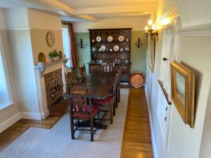 uma sala de jantar com uma mesa longa e cadeiras em Mill House Bed and Breakfast em Cromer