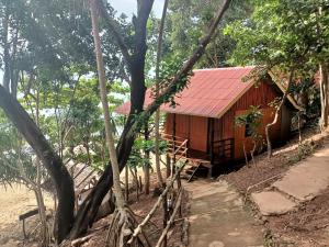 a cabin in the woods with a red roof at Jungle Hill Beach Bungalow in Ko Jum