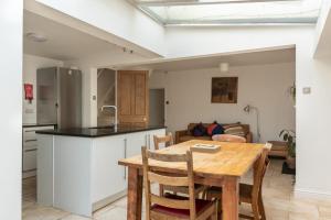 a kitchen and dining room with a wooden table at GuestReady - A Bohemian Home in Bath in Bath