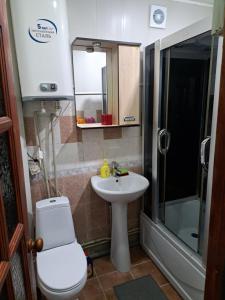 uma casa de banho com um WC, um lavatório e um chuveiro em Душа у моря em Pitsunda