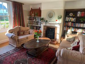 a living room with two couches and a coffee table at Mill House Bed and Breakfast in Cromer