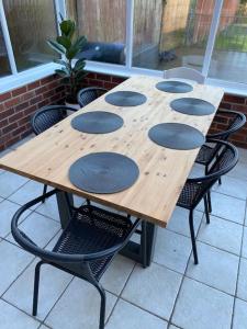 una mesa de madera con 4 sillas alrededor en 3BD Sanctuary in Beeston, Nottinghamshire en Beeston