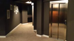 an empty hallway with two elevators and a door at Studio Tia in Mamaia