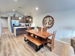 cocina y comedor con mesa de madera y sillas en Modern Style KING bed Free Wi-Fi with Garage, en Spokane Valley