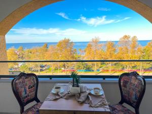 a table with a view of the ocean from a window at Sera Lake Center Hotel in Akcaabat