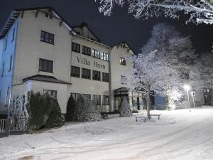 a large white building in the snow at night at NEU - Familienfreundlich - Für bis zu 6 Personen in Oberhof