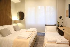 a bedroom with two beds with white towels on them at Meyland suites centro in Milan