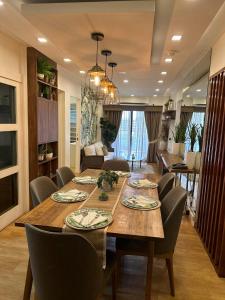 a dining room with a large wooden table and chairs at KAMALA 503 ACACIA ESTATE TAGUIG CITY in Manila