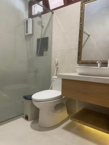 a bathroom with a toilet and a sink and a shower at H&ograve;n Cau Resort & Restaurant in Tuy Phong