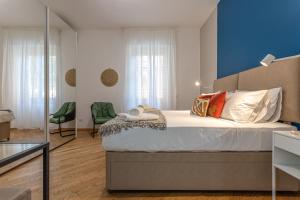 a bedroom with a large bed with a blue wall at Casa Abeba a Torre Maura in Rome
